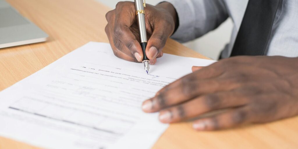 person signing a document