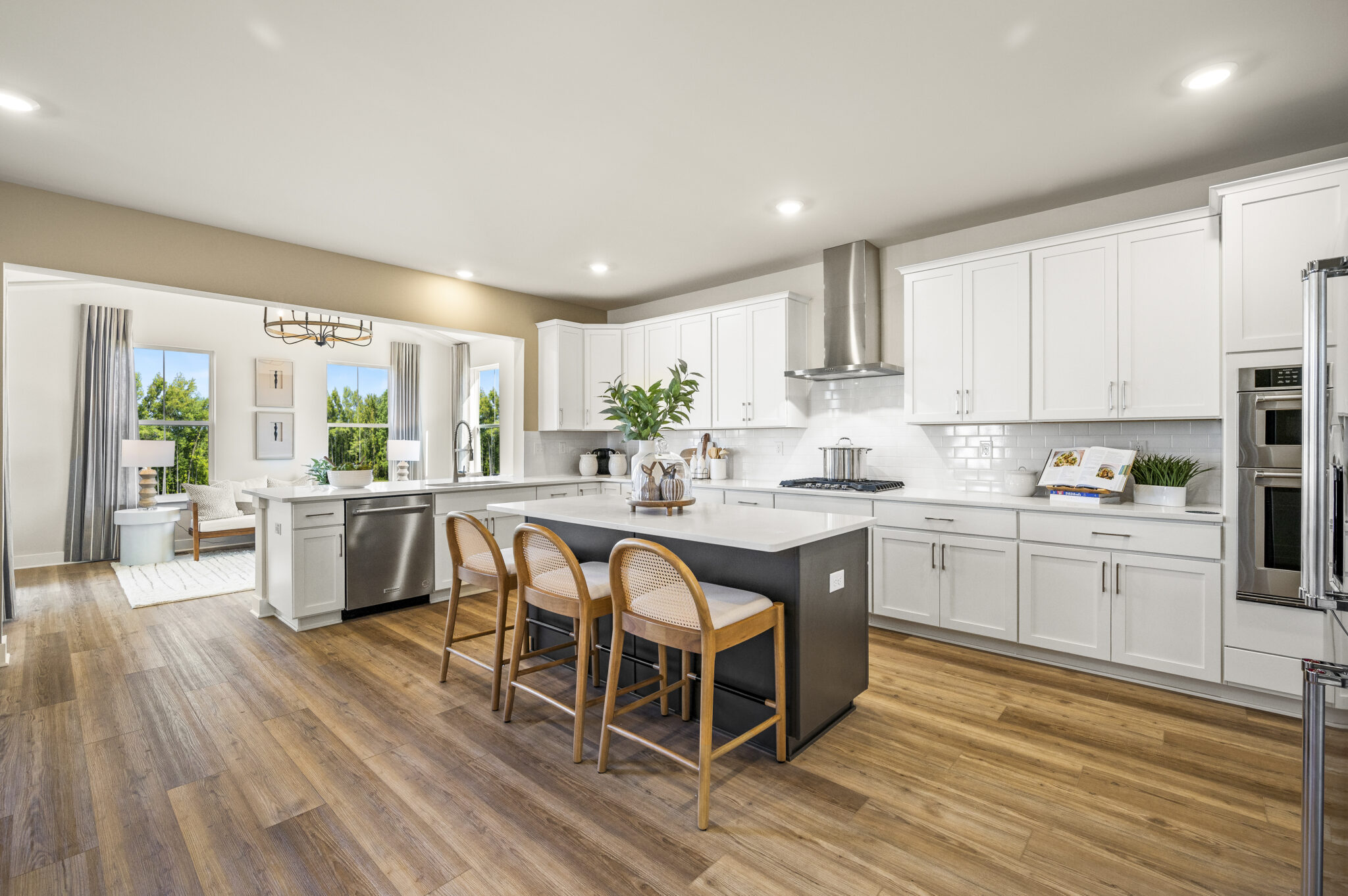open kitchen with white cabinets and brown island